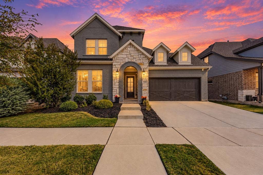 Sunset photo of the front of home of 1302 20th St, Argyle, TX in Harvest by Hillwood