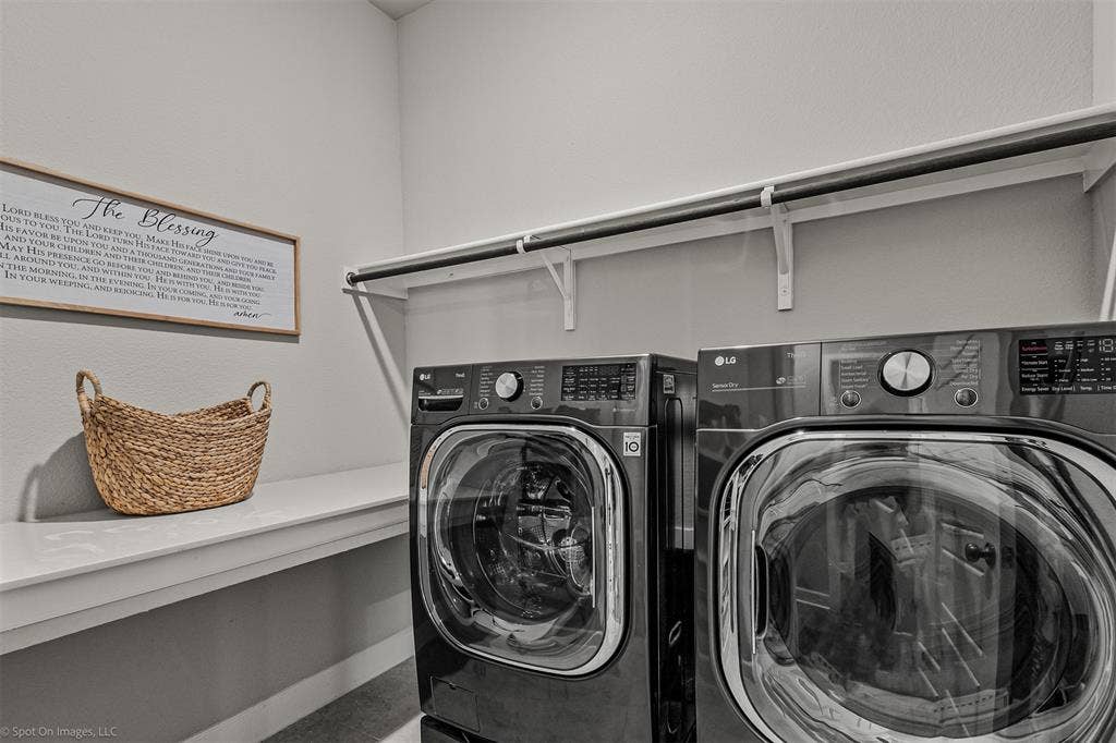 Large laundry room with hanging storage and counter space of 1302 20th St, Argyle, TX in Harvest by Hillwood