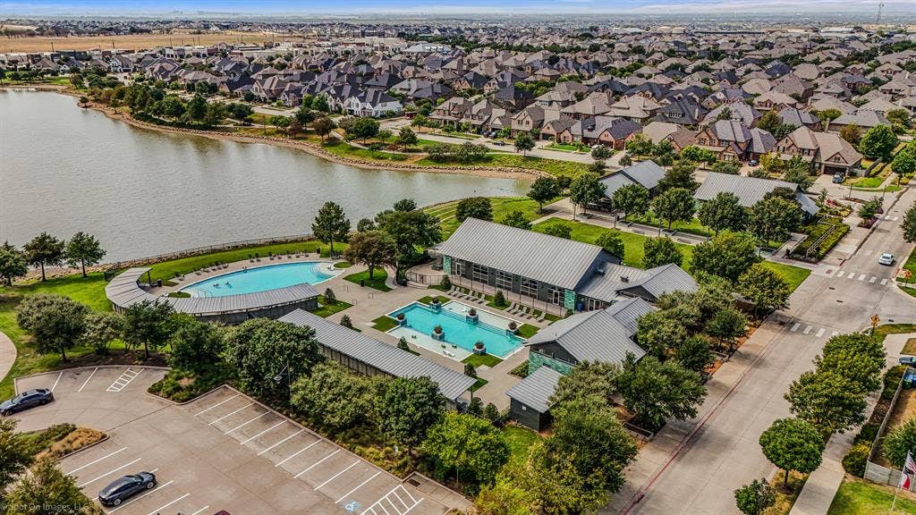 Two large pools with the large pond at the Amenity Center South located in Argyle, Texas in Harvest by Hillwood for 1302 20th St. in Denton County. Both of these amenity centers have state of the art workout centers.