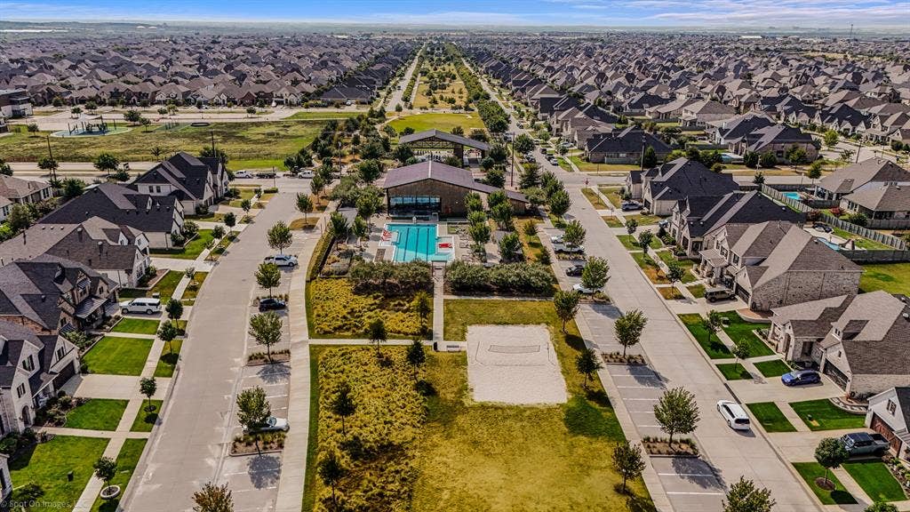 Pool with sand volleyball courts in the Amenity Center North located in Argyle, Texas in Harvest by Hillwood for 1302 20th St. in Denton County. Both of these amenity centers have state of the art workout centers.