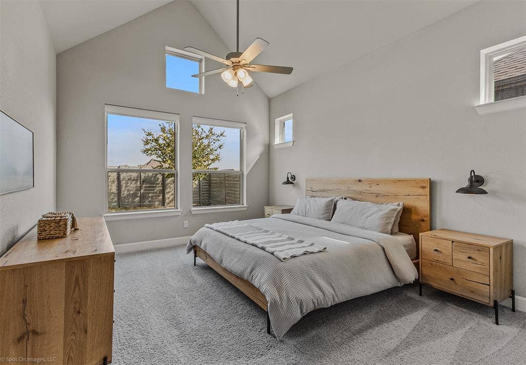 Downstairs primary bedroom with tall ceilings of 1302 20th St, Argyle, TX in Harvest by Hillwood