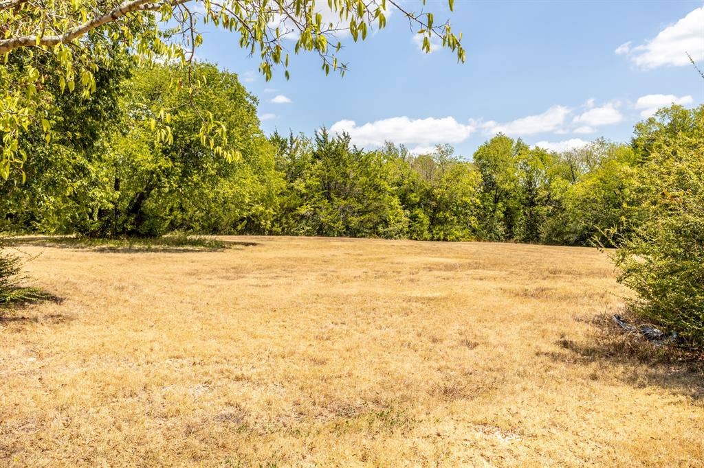 2300 W MAIN Street, Lancaster, TX 75146 In a few weeks this wil green and leaves turning fall colors.of open field by home