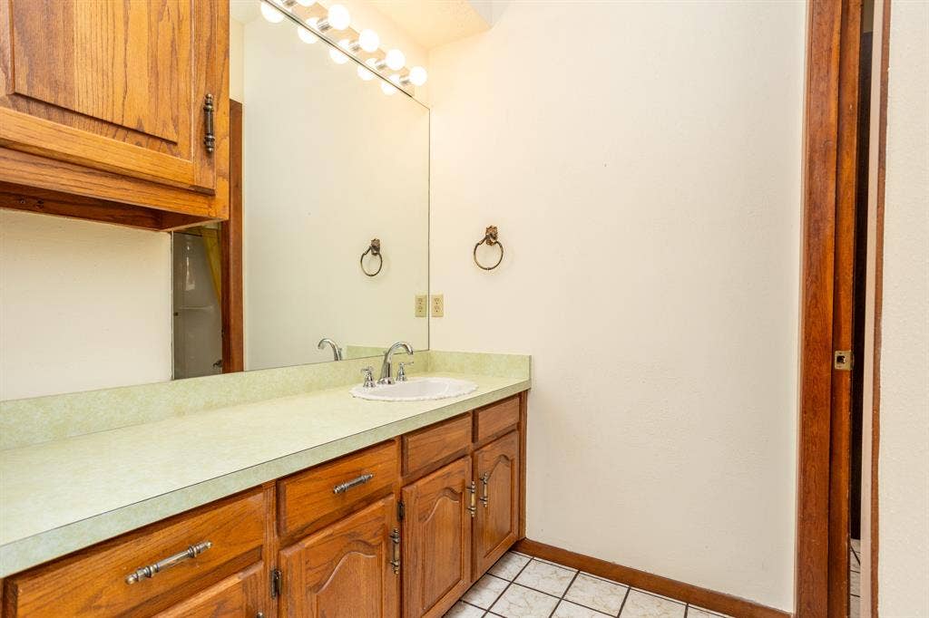 2300 W MAIN Street, Lancaster, TX 75146 Jack and Jill bath vanity with storage.