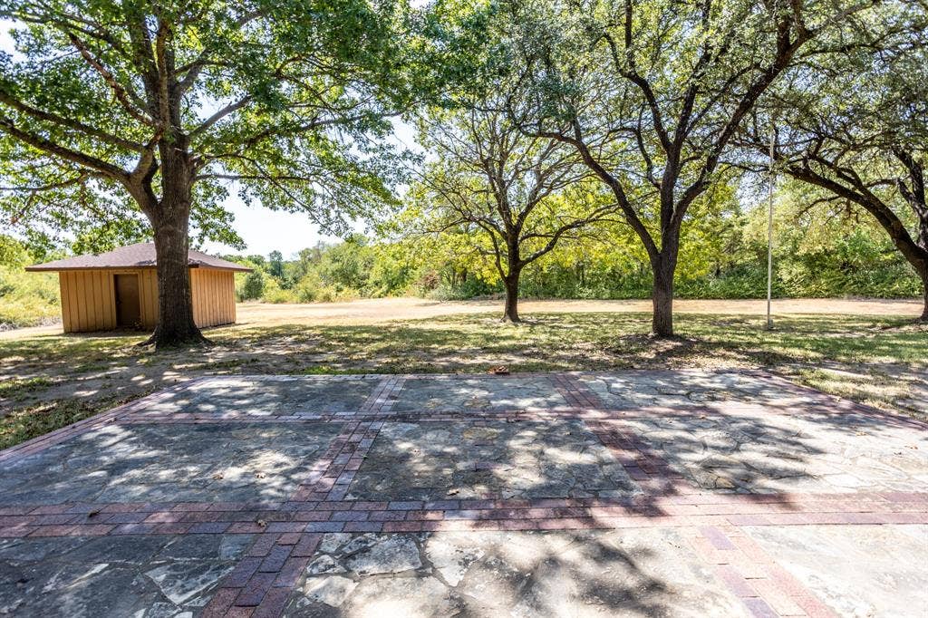 2300 W MAIN Street, Lancaster, TX 75146 Looking from patio to back area with small storage building.