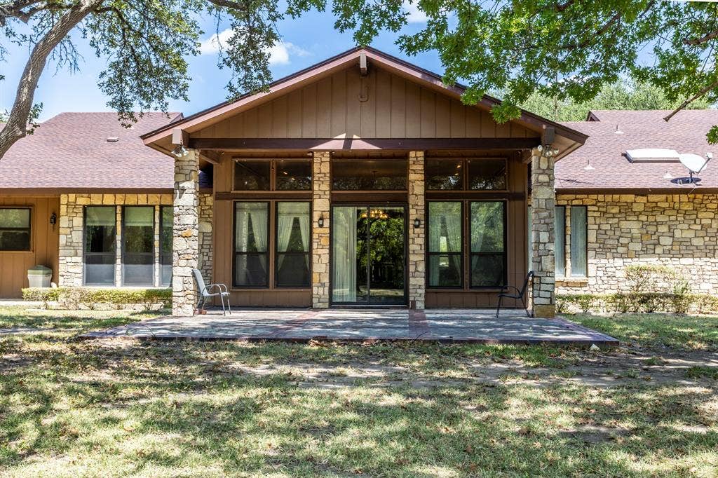 2300 W MAIN Street, Lancaster, TX 75146 Back patio area offers a space to relax and enjoy nature and listen to the water as it runs over the white rocks just below this site.