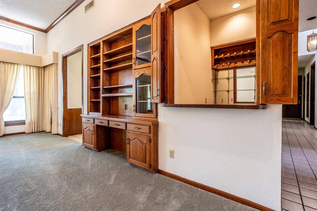 2300 W MAIN Street, Lancaster, TX 75146 Built-in and wet bar also shows hall going toward side door.
