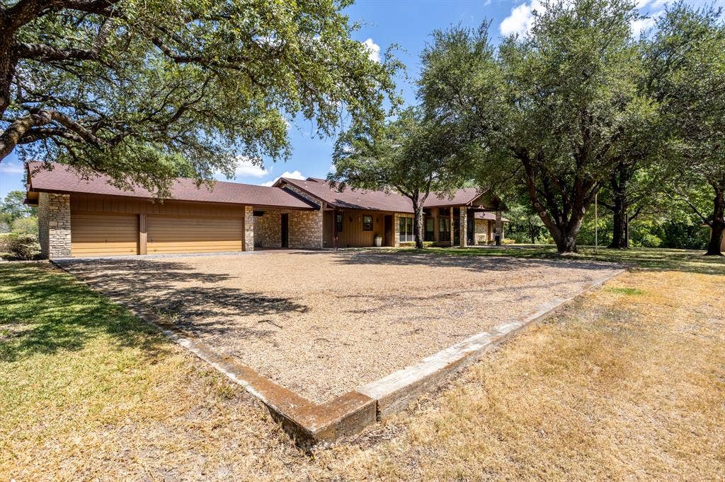 2300 W MAIN Street, Lancaster, TX 75146 Back view showing shade trees and retaining walls designed when structure was raised above flood way.