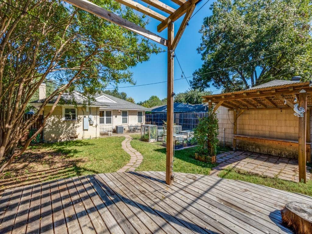 6150 Ravendale Lane, Dallas, TX 75214 Wooden terrace with a patio, a fenced backyard, and a pergola