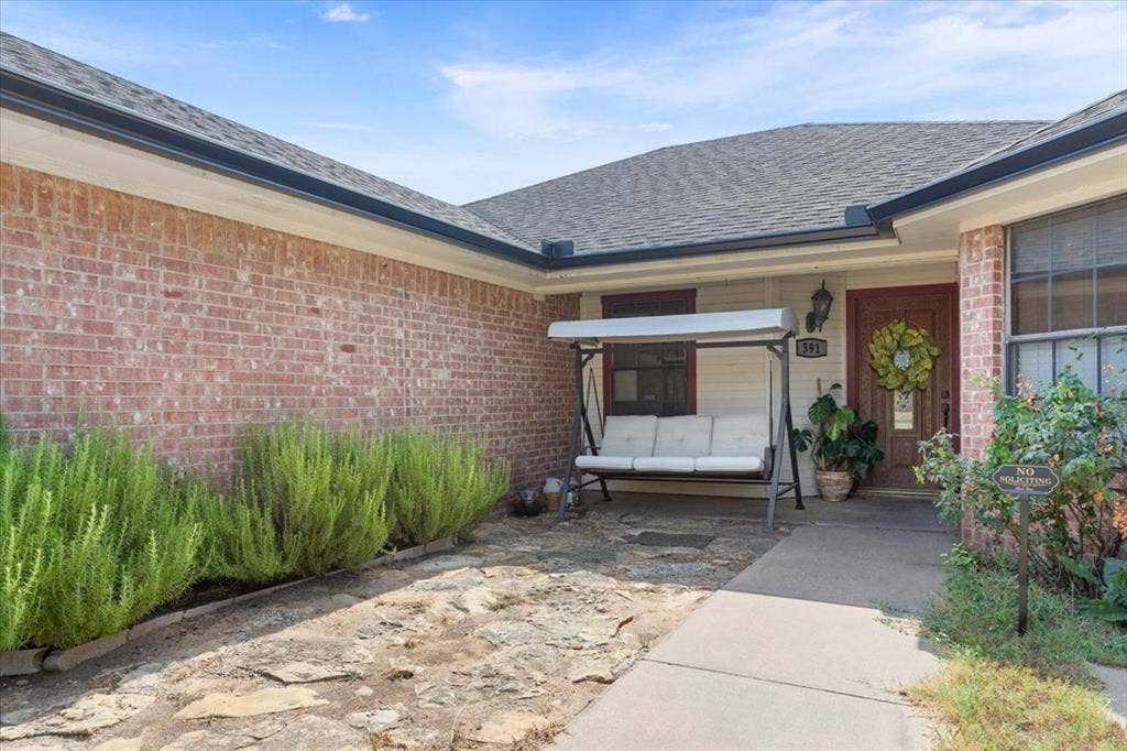 Brick exterior with a dark asphalt shingle roof