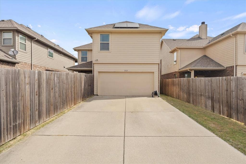 1225 Honeywood Lane, Royse City, TX 75189 Private fenced yard featuring a concrete driveway and an attached garage