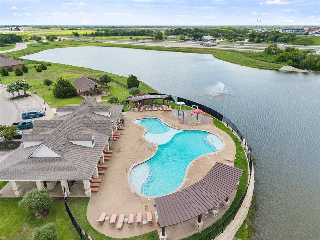 1225 Honeywood Lane, Royse City, TX 75189 Community pool with integrated water features, adjacent to a large body of water
