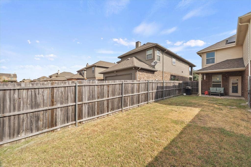 1225 Honeywood Lane, Royse City, TX 75189 Fenced backyard with a covered patio, brick and siding exterior, and a glass-paneled back door