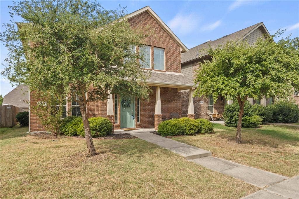 1225 Honeywood Lane, Royse City, TX 75189 Brick exterior facade with a covered entry, established landscaping, a concrete walkway, and a partial privacy fence