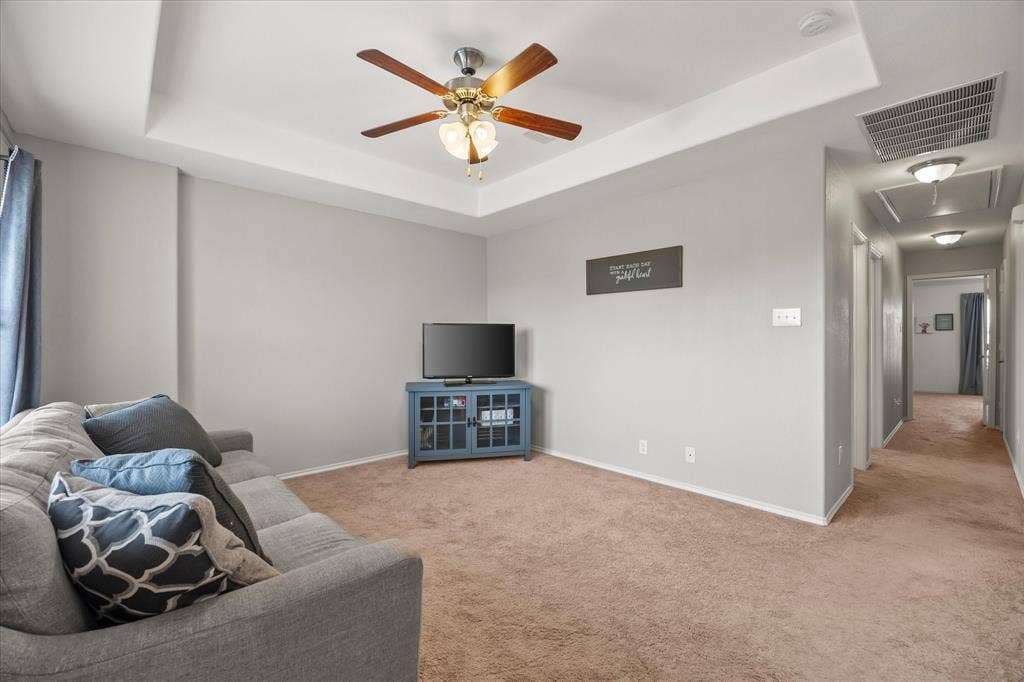 1225 Honeywood Lane, Royse City, TX 75189 Tray ceiling with a ceiling fan, light gray wall paint, and brown carpeting