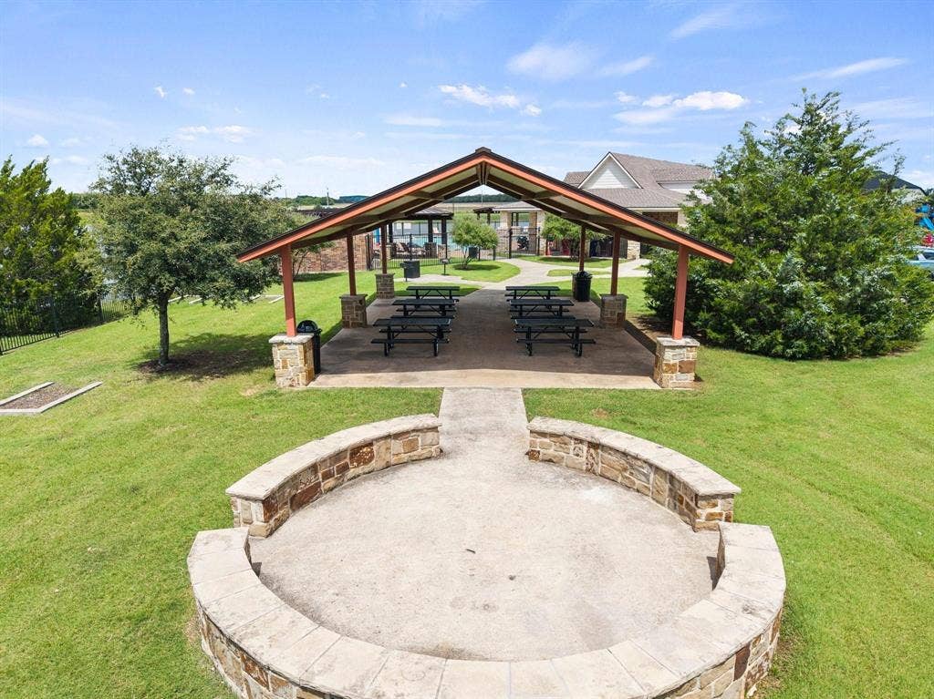 1225 Honeywood Lane, Royse City, TX 75189 Covered outdoor pavilion with stone-clad columns, a concrete floor, and an open gable roof