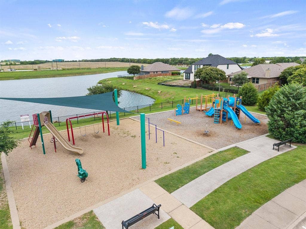 1225 Honeywood Lane, Royse City, TX 75189 Community playground featuring multiple slides, swings, and climbing structures