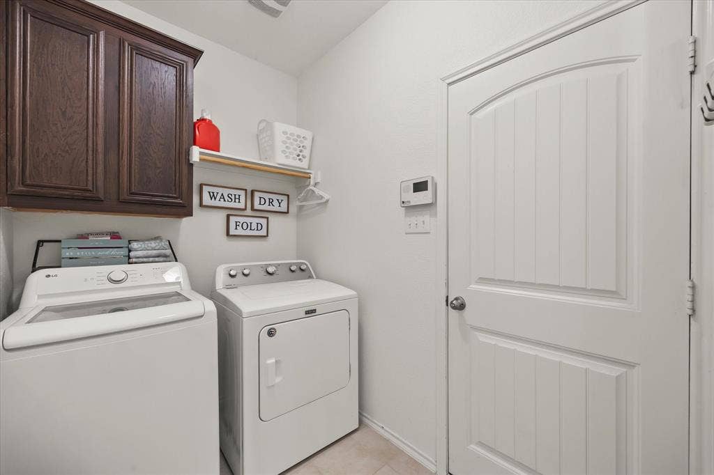 1225 Honeywood Lane, Royse City, TX 75189 Warm wood-finish cabinetry provides storage above a floating shelf