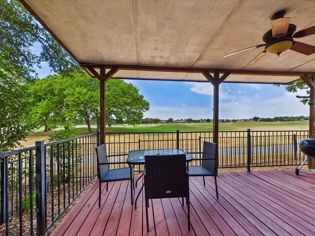 Covered wood-finish deck with a ceiling fan