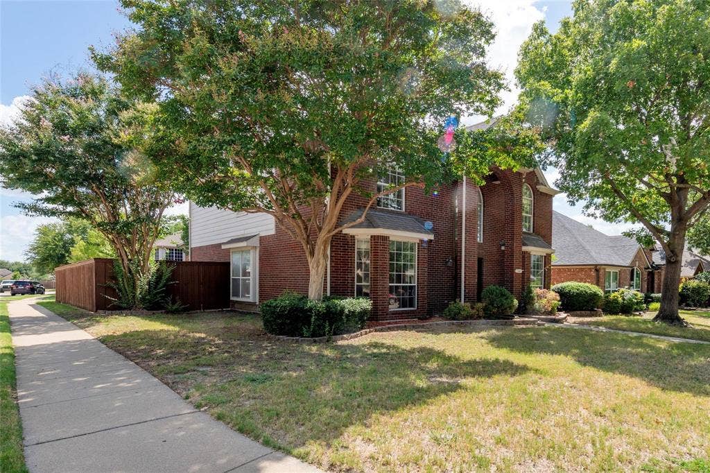 11443 Waterford Lane, Frisco, TX 75035 Traditional brick exterior featuring a multi-level design and arched windows