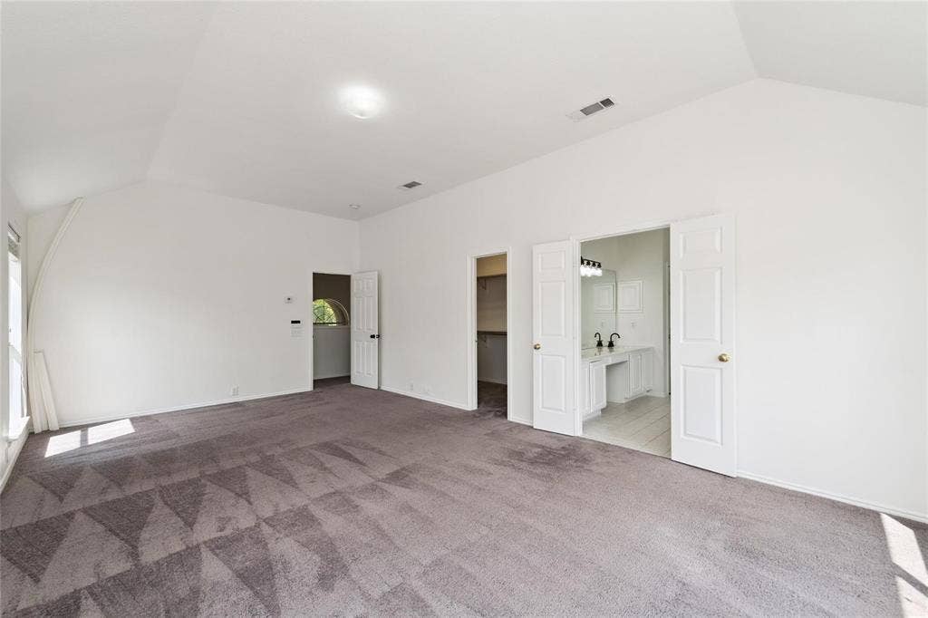 11443 Waterford Lane, Frisco, TX 75035 Spacious room featuring vaulted ceilings, a large window, and carpet flooring