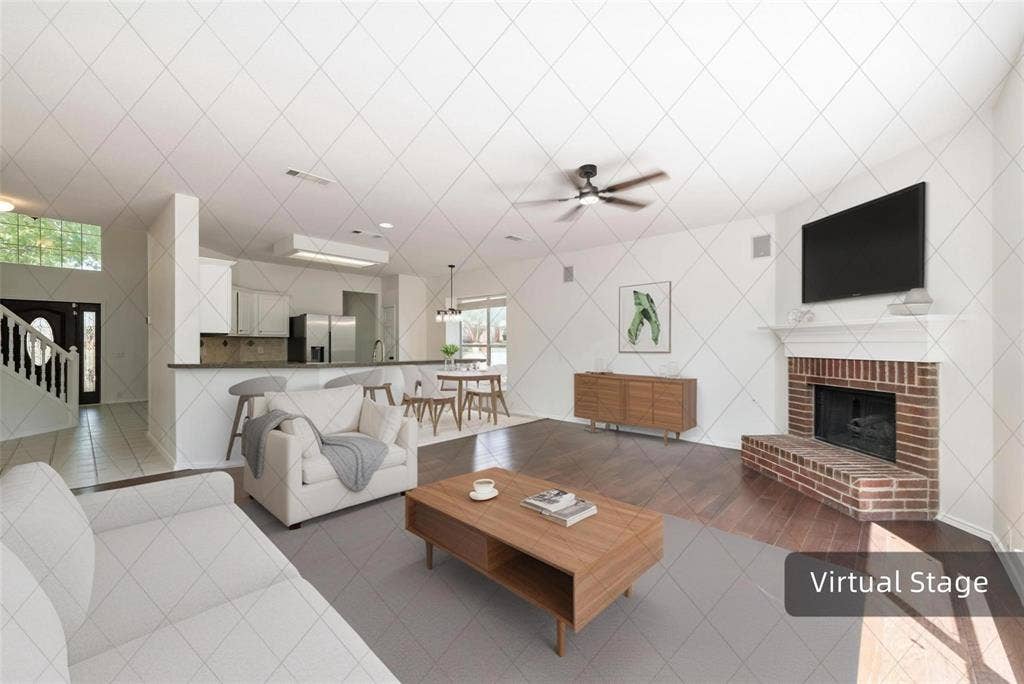 11443 Waterford Lane, Frisco, TX 75035 Brick fireplace with a substantial hearth and mantel, dark wood-finish flooring, and a ceiling fan