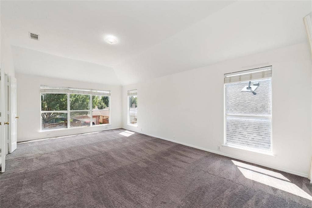 11443 Waterford Lane, Frisco, TX 75035 Vaulted ceiling with an overhead light fixture, light gray wall paint, and gray carpet flooring