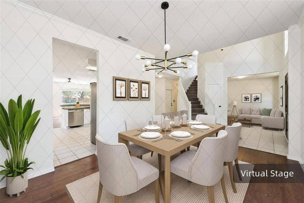 11443 Waterford Lane, Frisco, TX 75035 Wood-finish flooring, contemporary chandelier, stainless steel appliances, tiled kitchen flooring, and a staircase with white balusters