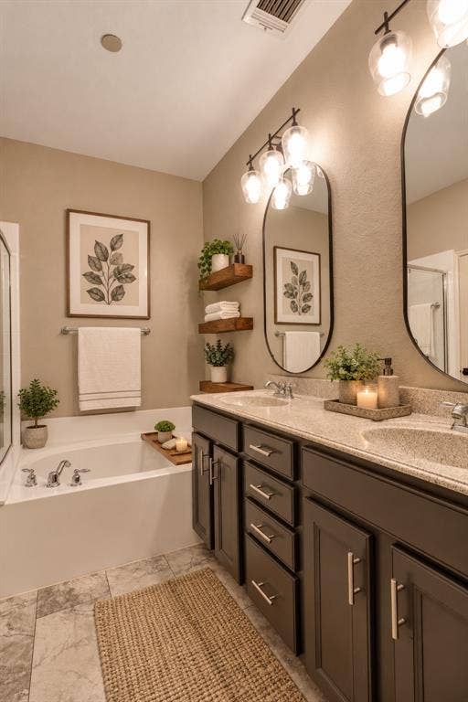 6854 Cortona Lane, Frisco, TX 75034 Dual vanities with integrated sinks, framed mirrors, and overhead lighting fixtures