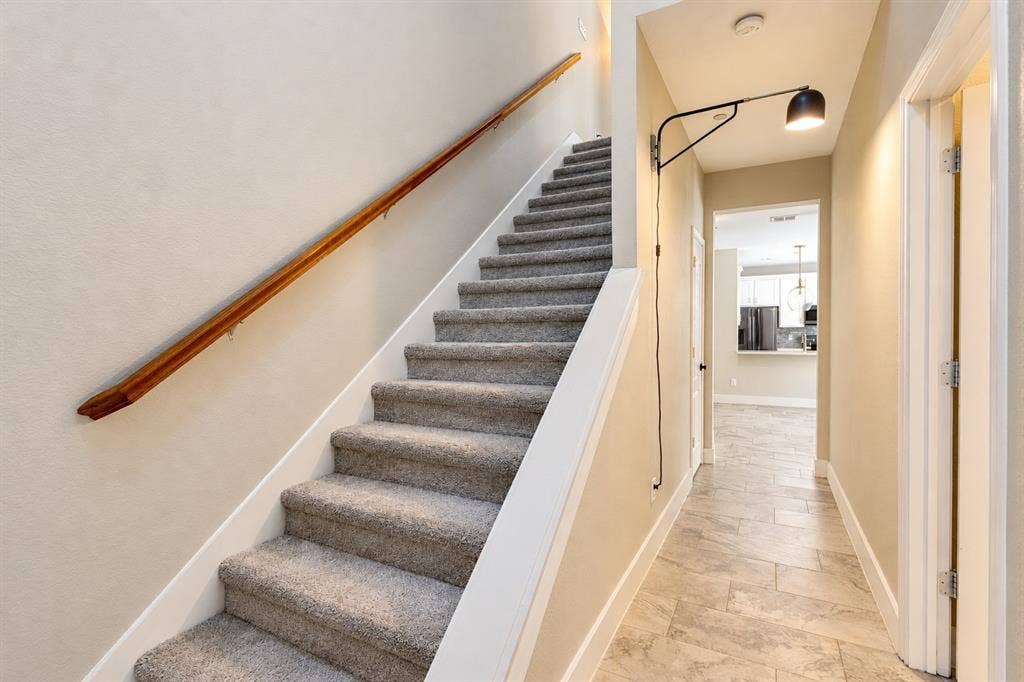 6854 Cortona Lane, Frisco, TX 75034 Carpeted staircase with a wood-finish handrail
