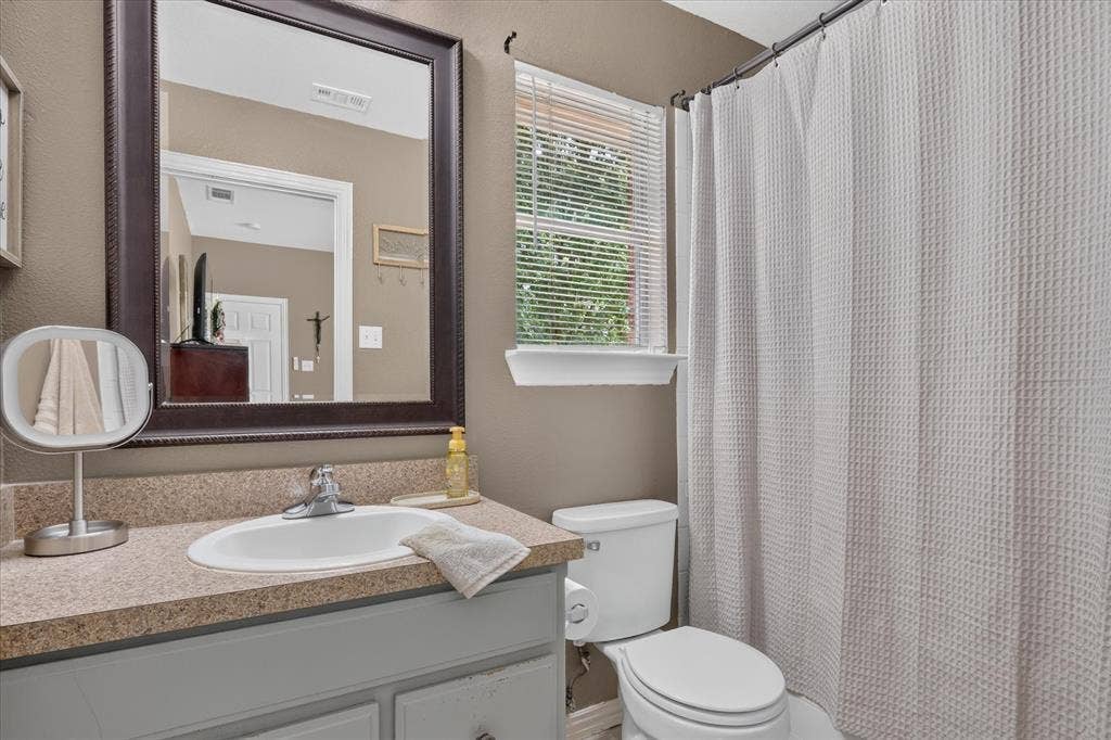 5413 Cornell Avenue, River Oaks, TX 76114 Vanity with integrated sink, chrome faucet, and a large framed mirror