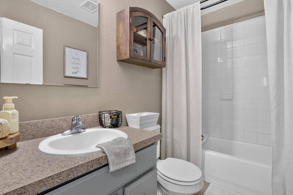 5413 Cornell Avenue, River Oaks, TX 76114 White subway tile bath/shower combination with a built-in soap dish