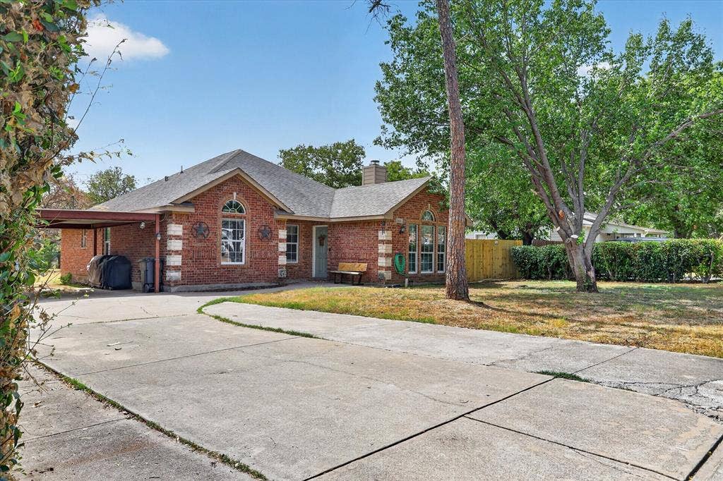 5413 Cornell Avenue, River Oaks, TX 76114 Brick exterior with a gabled roof and arched window