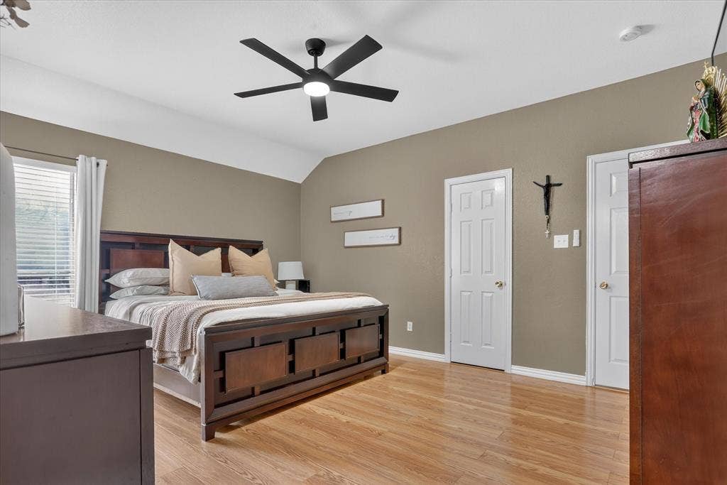 5413 Cornell Avenue, River Oaks, TX 76114 Wood-finish flooring with a modern ceiling fan, white paneled doors, and a window with blinds