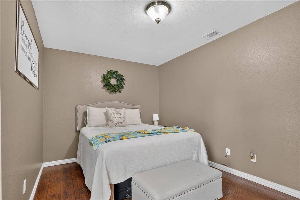 5413 Cornell Avenue, River Oaks, TX 76114 Wood-finish flooring with white trim and neutral wall tones