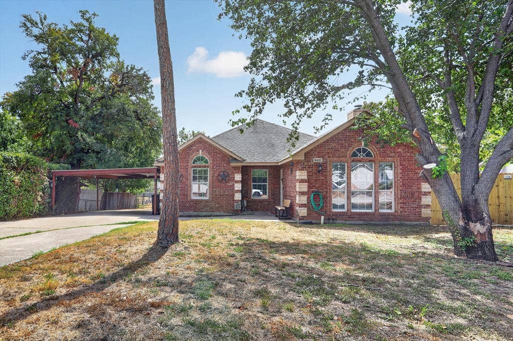 5413 Cornell Avenue, River Oaks, TX 76114 Brick exterior with a gabled roof and arched window accents