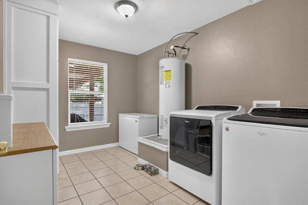 5413 Cornell Avenue, River Oaks, TX 76114 Tile flooring, built-in cabinetry with wood-finish countertop, window with blinds, overhead lighting, and neutral wall paint