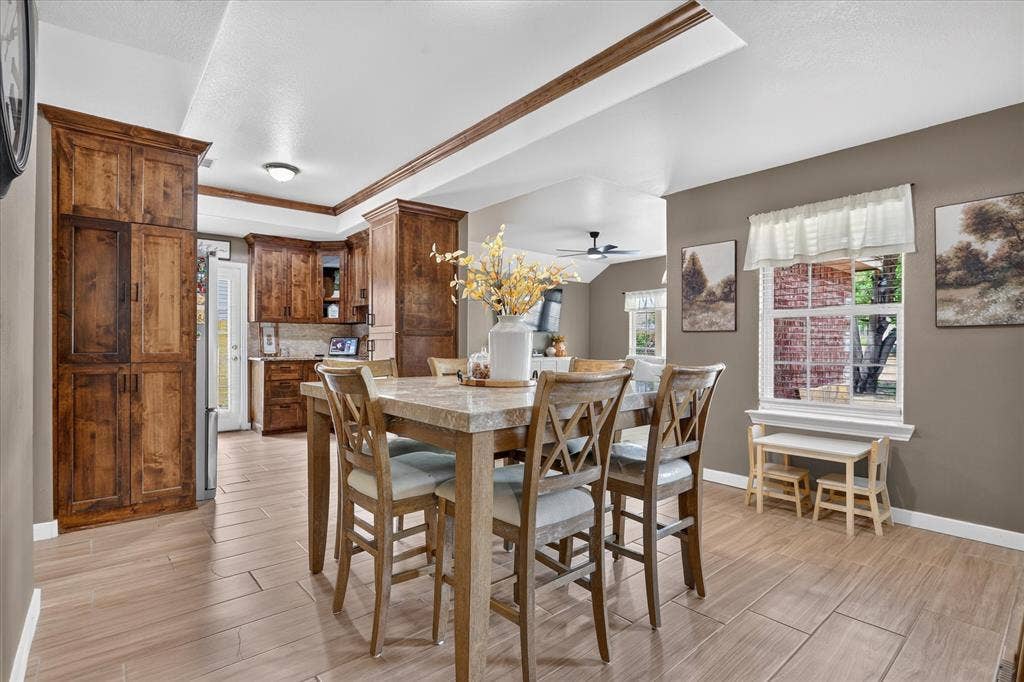 5413 Cornell Avenue, River Oaks, TX 76114 Warm wood-finish cabinetry, light wood-finish flooring, recessed ceiling lighting, and a kitchen pass-through