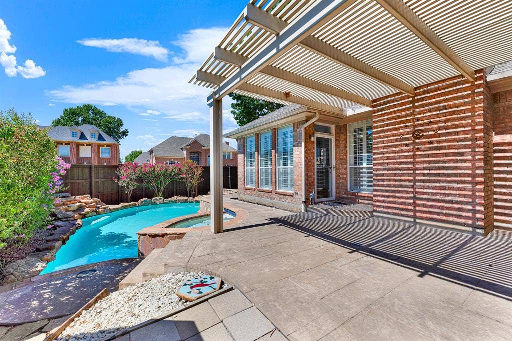 4020 MAYFLOWER Lane, Plano, TX 75024 The shaded patio lounge steps down directly toward a pristine back pool setup. Transition easily from lounging under the pergola to taking a refreshing swim.