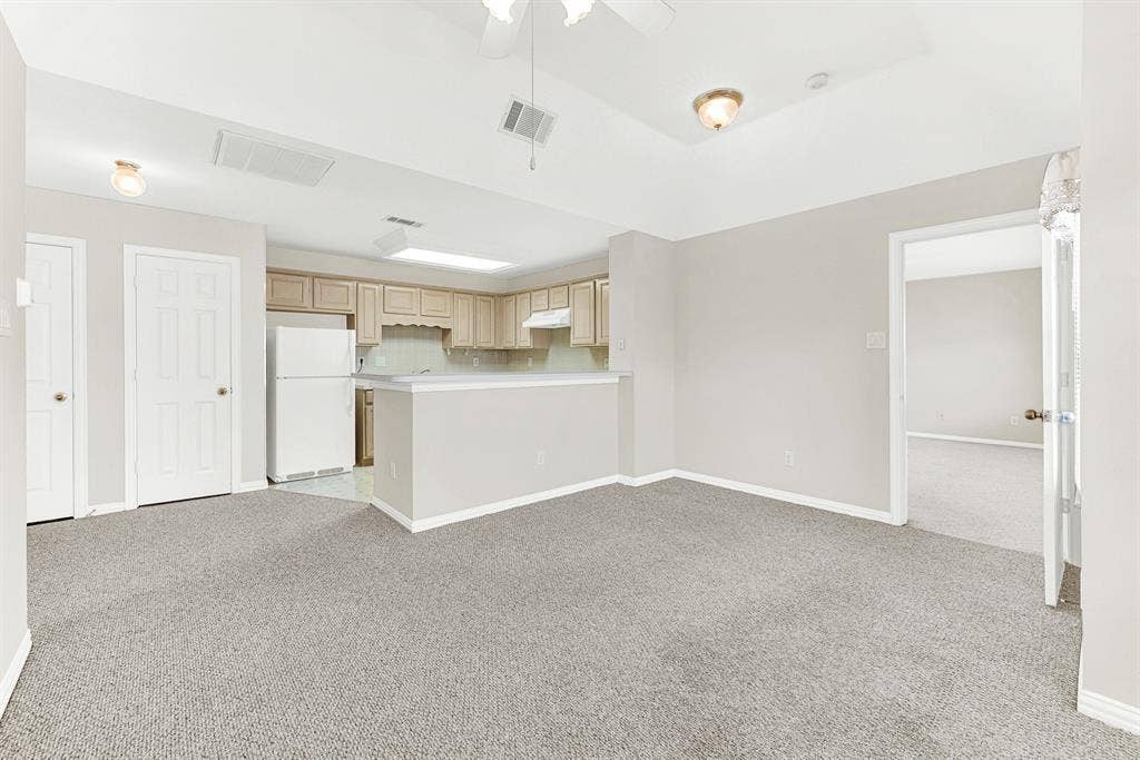 4020 MAYFLOWER Lane, Plano, TX 75024 The open living zone flows effortlessly toward both the private bedroom suite entrance and the dedicated kitchen area. Enjoy quiet independence while staying connected under the same roof