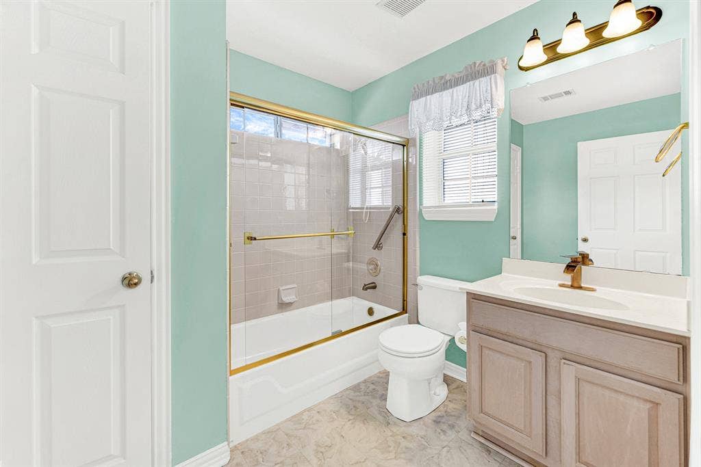 4020 MAYFLOWER Lane, Plano, TX 75024 Refreshing seafoam green walls frame a full tub-and-shower combination and single vanity. Pamper yourself in complete comfort within your own private bath