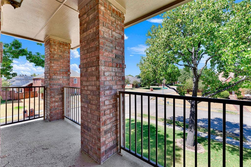 4020 MAYFLOWER Lane, Plano, TX 75024 The covered second-floor balcony offers a private outdoor retreat framed by sturdy brick pillars and railing, overlooking the tree-lined neighborhood and front lawn. Step outside to sip your morning coffee while enjoying elevated neighborhood views.