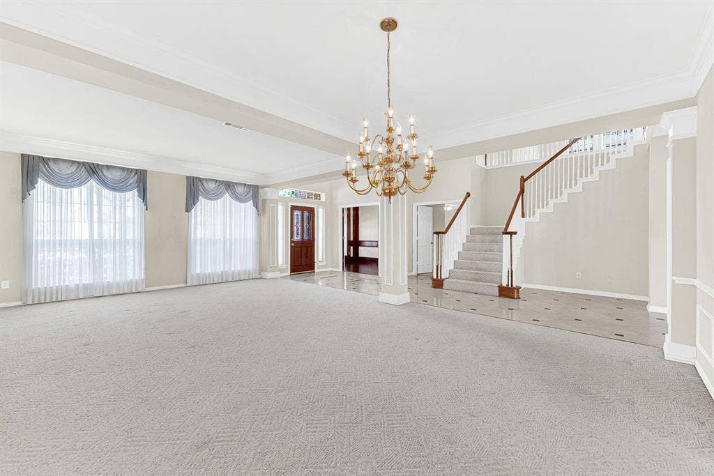4020 MAYFLOWER Lane, Plano, TX 75024 An ornate brass chandelier serves as a graceful central anchor above the vast expanse of soft carpet. It offers a warm setting to unwind with a good book on a quiet weekend afternoon.