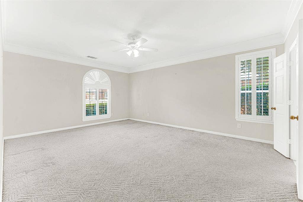4020 MAYFLOWER Lane, Plano, TX 75024 A classic arched window with custom shutters provides a focal point against muted neutral walls in this ground-floor primary retreat. Wake up refreshed as soft daylight gently fills the room each morning