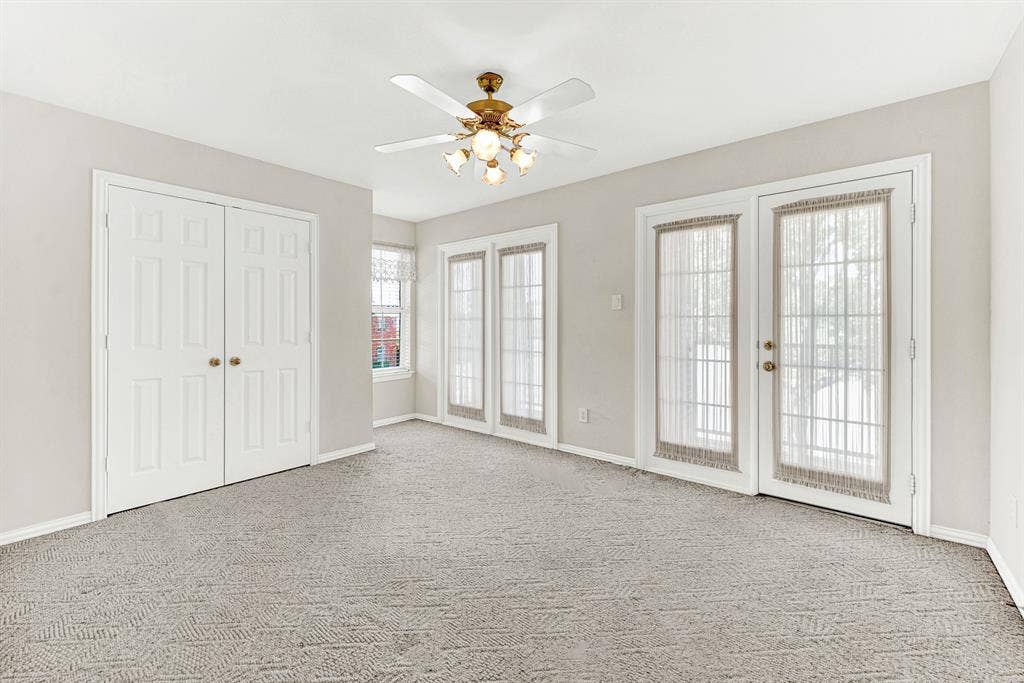 4020 MAYFLOWER Lane, Plano, TX 75024 This spacious second-floor bedroom features plush neutral carpeting, a double-door closet, and two sets of French doors opening directly out to the upper balcony. Wake up to soft natural light and enjoy effortless indoor-outdoor flow right from your bedroom.