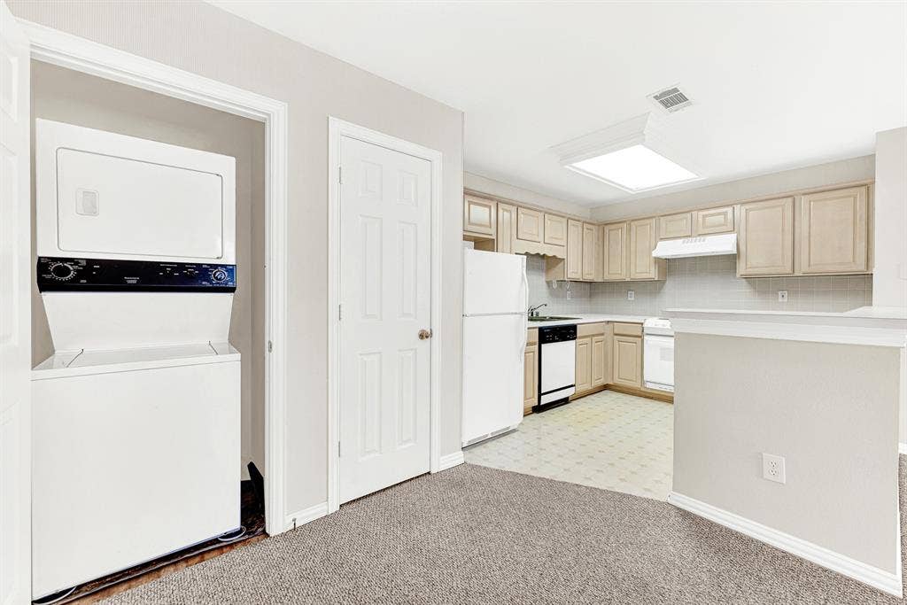 4020 MAYFLOWER Lane, Plano, TX 75024 A dedicated utility closet tucked right beside the kitchen holds a stacked washer and dryer setup. Handle laundry day effortlessly without having to carry baskets downstairs.