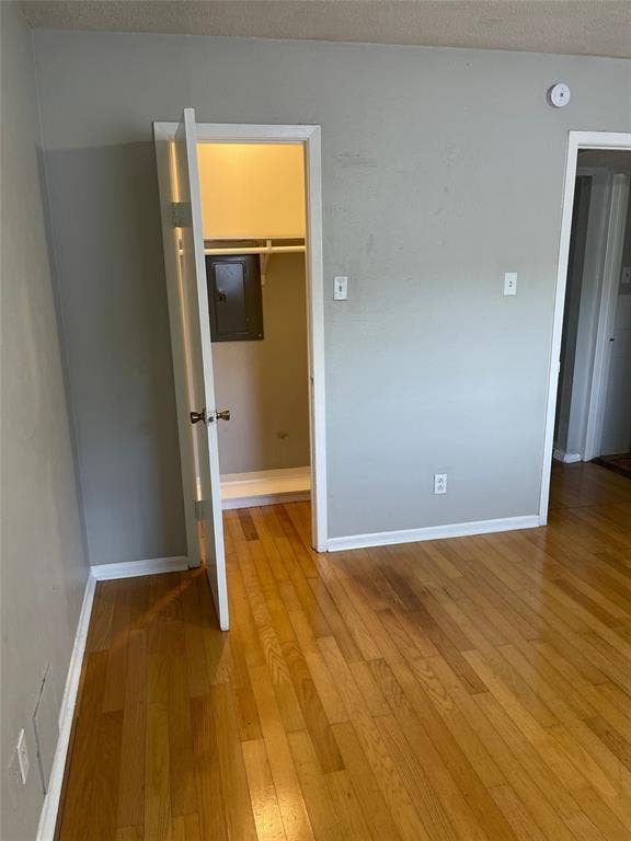 5317 Junius Street, #214, Dallas, TX 75214 Wood-finish flooring throughout, light gray wall finishes, and white trim