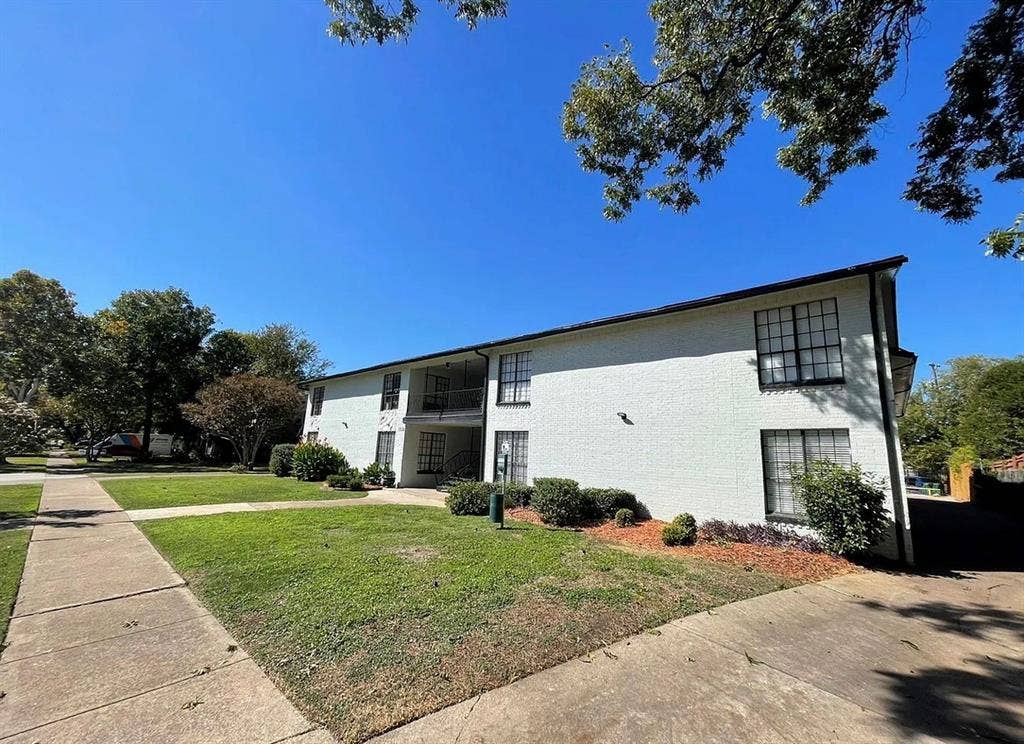 5317 Junius Street, #214, Dallas, TX 75214 Two-story building featuring a painted brick exterior and dark trim