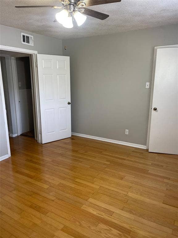 5317 Junius Street, #214, Dallas, TX 75214 Wood-finish flooring with light gray wall paint and white trim