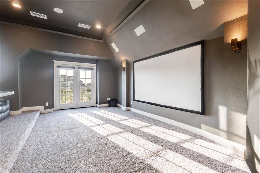 4102 Parkview Boulevard, Celina, TX 75009 Projector screen, wall sconces, recessed lighting, French doors, and light-toned carpeting