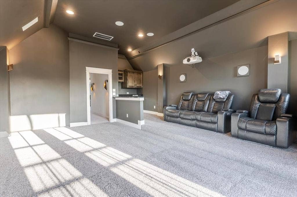 4102 Parkview Boulevard, Celina, TX 75009 Recessed lighting, built-in projector, wall-mounted sconces, light gray carpeting, and a built-in wet bar with wood-finish cabinetry